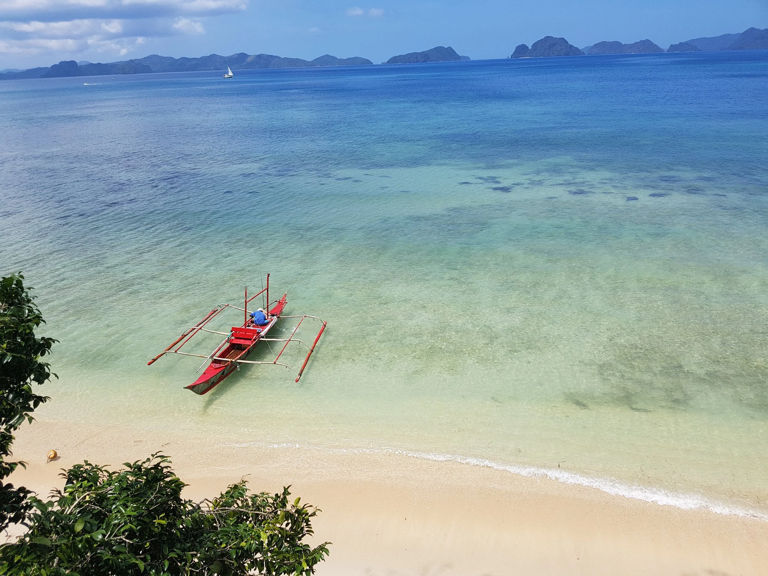 A boat on a serene beach at sunset